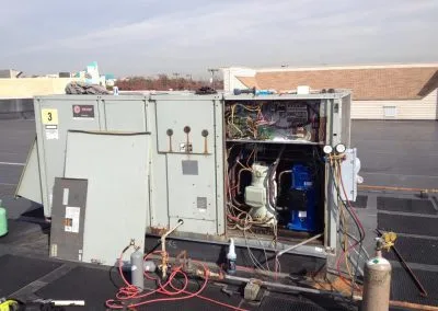 FixGrid AI HVAC technician on a rooftop unit in Laurel, MD